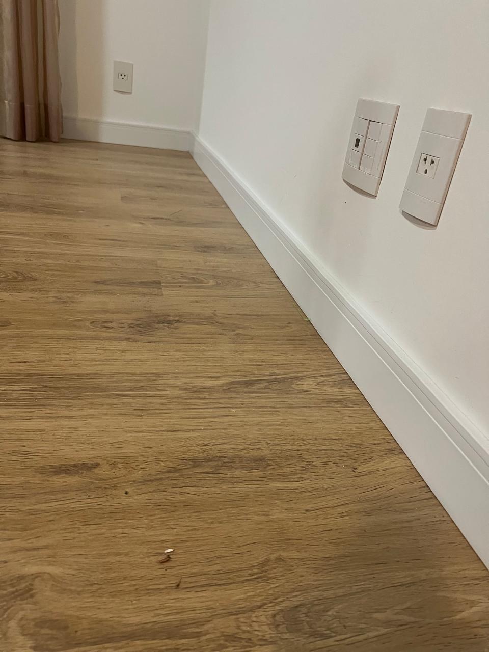 Piso vinílico com rodapé branco em quarto